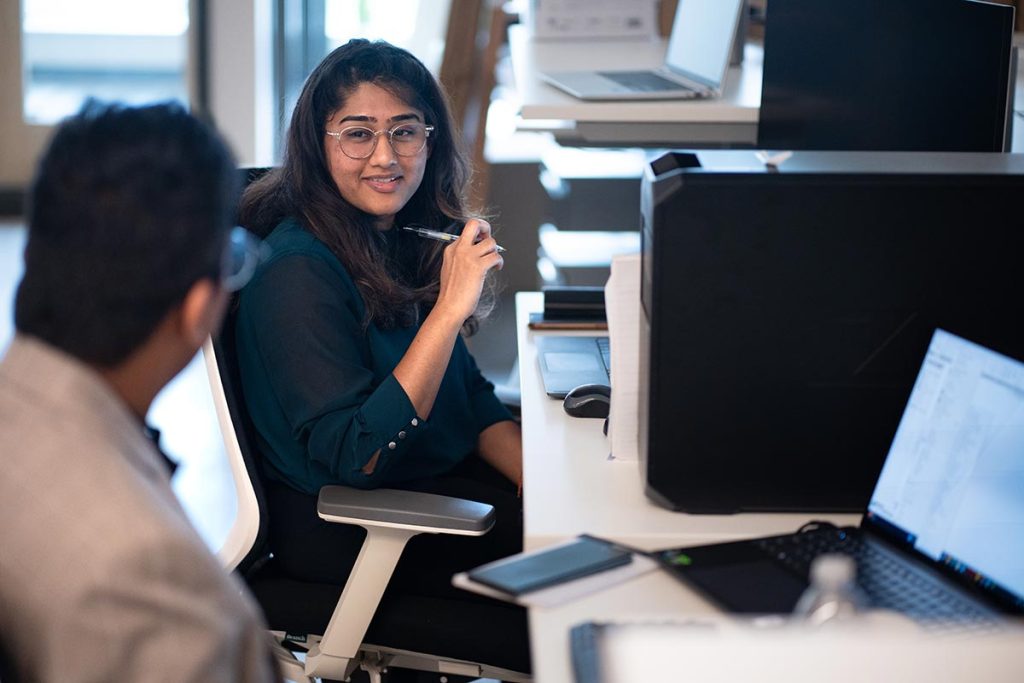 Type One Energy employees at desk photo
