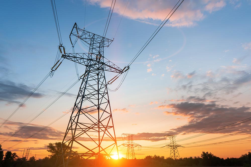 sunrise behind electrical power lines photo
